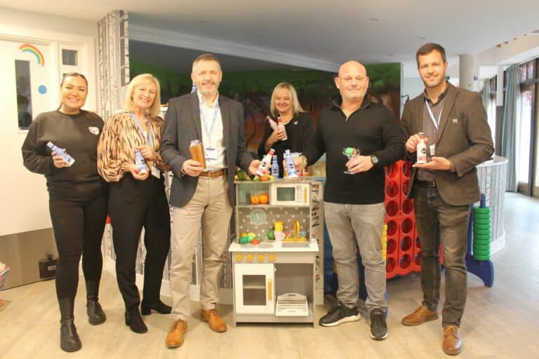 Representatives from Little Havens and Tapp'd cocktails at Little Havens holding tapp'd bottles and a cocktail shaker