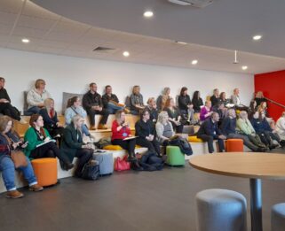 Local schools and groups sitting down watching a presentation