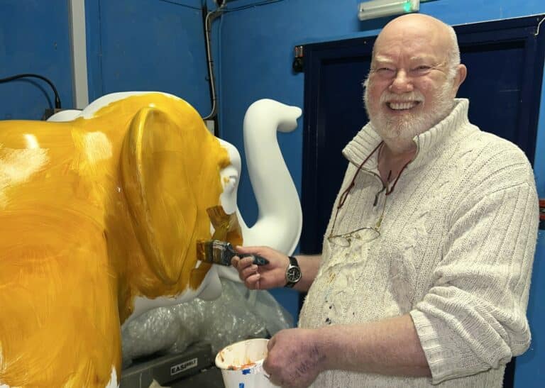 John Bulley, artist, painting elephant sculpture in gold colour