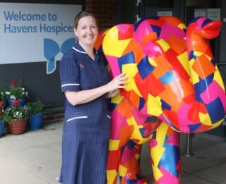 Pamela Houghton, Fair Havens Ward Manager standing next to Duke, a large patchwork elephant
