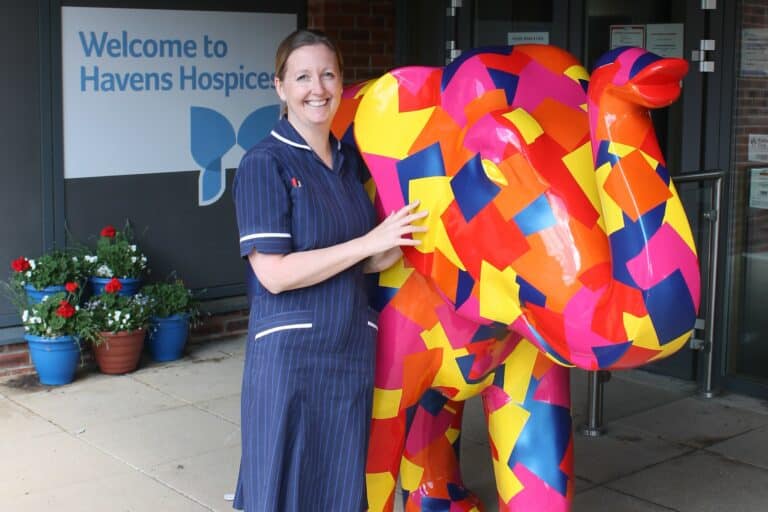 Pamela Houghton, Fair Havens Ward Manager standing next to Duke, a large patchwork elephant