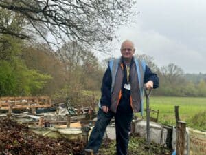 Clifford Churchill standing on the compost heap surrounded by green space