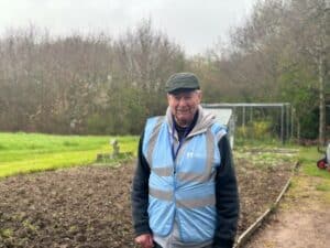 Douglas Barnes standing in front of the allotments at Little Havens
