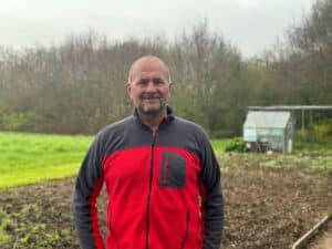 Paul Samways standing in front of the allotments at Little Havens