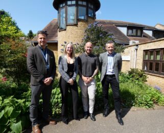 Tom Abbott and Steve Smith from Havens Hospices stand outside Little Havens with two representatives from Highview