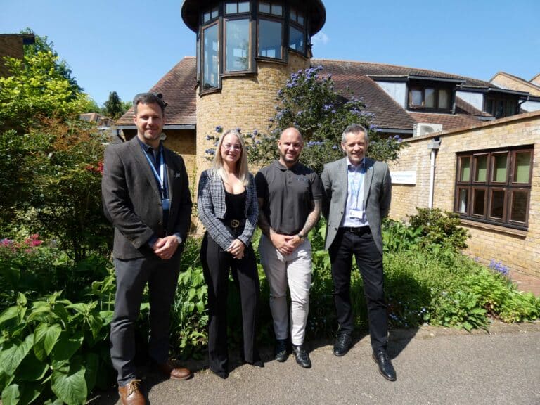 Tom Abbott and Steve Smith from Havens Hospices stand outside Little Havens with two representatives from Highview