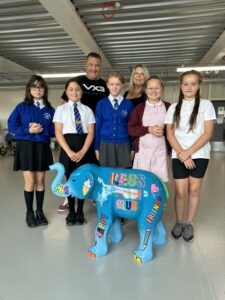 Members of KAOS Youth Club standing next to their baby elephant sculpture
