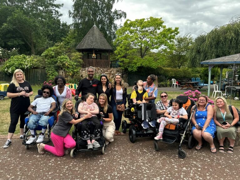 Simon and Ayshen Webbe with families in the garden of Little Havens