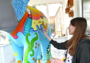 Painting a nautical theme on an elephant sculpture