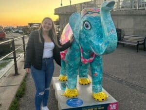 Taylor Crawford standing next to elephant sculpture Eleigh on Sea