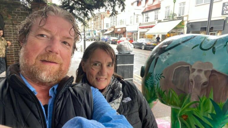 Steve and Cara Ayers standing next to an elephant sculpture
