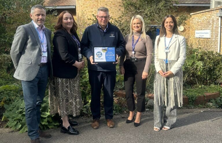 Two representatives from charity Havens Hospices and three representatives from DP World standing outside Little Havens holding a framed certificate