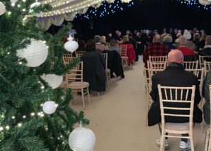 Christmas Tree in the foreground of a previous Light up a Life service.