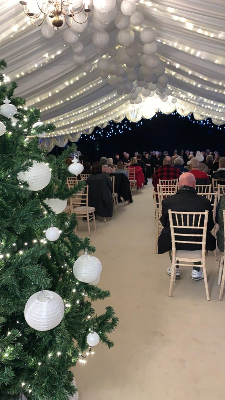 Christmas Tree in the foreground of a previous Light up a Life service.