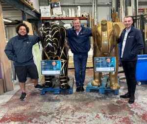 Staff from Talis Projects standing with two elephants