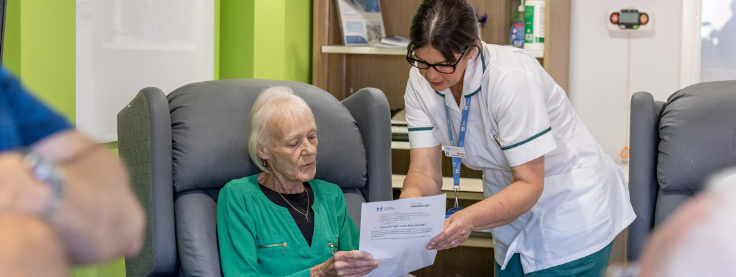 Occupational therapist showing a patient a piece of paper with information on it.