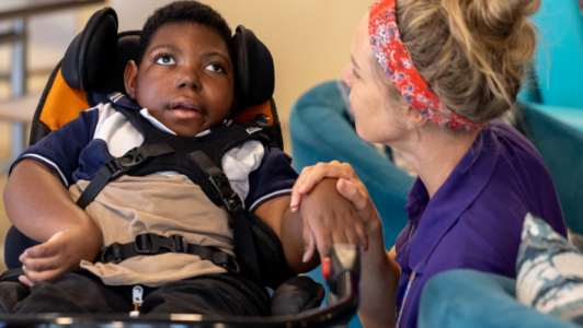 Little boy with a healthcare assistant at Little Havens