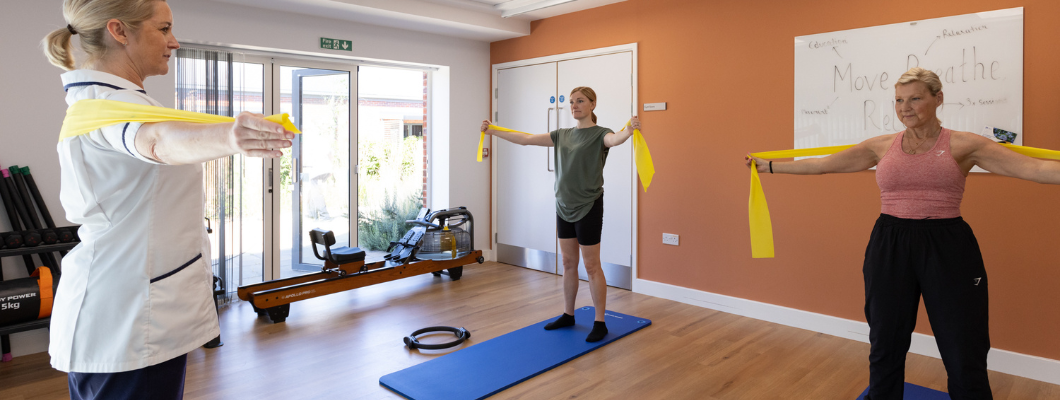 Two patients in a Pilates class