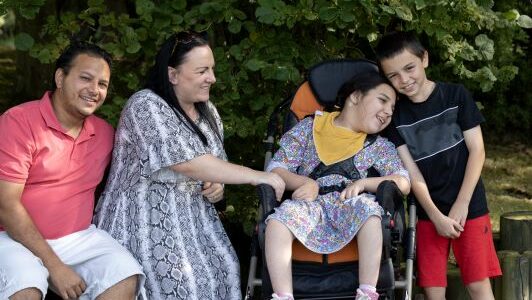 Alyssa with her family smiling.