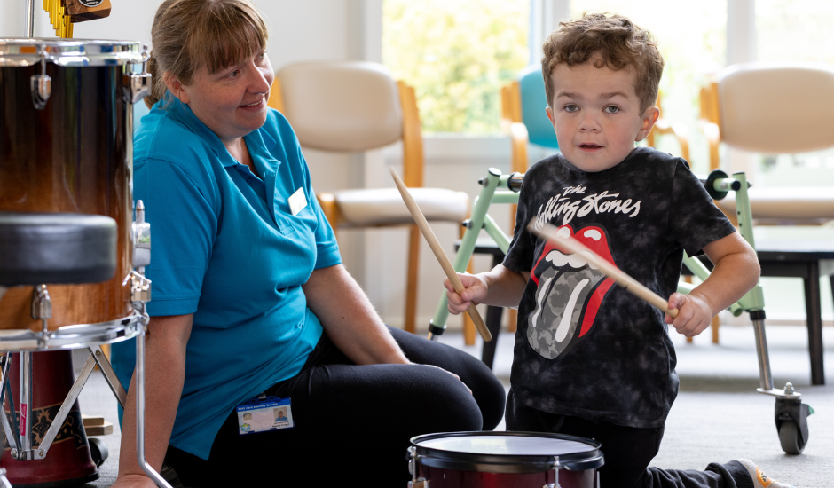 Lennie and Rachel sat playing the drums