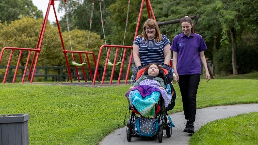 Elijah, Mum Natasha And Carer Emma walking in the Little Havens garden