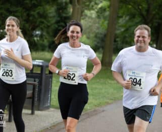 People smiling running Race4Business.