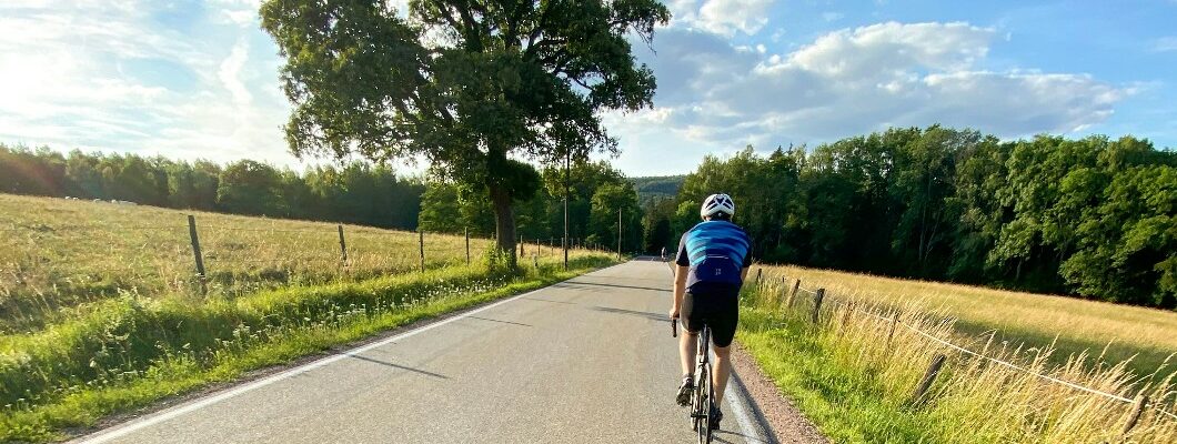 Man cycling through country side.