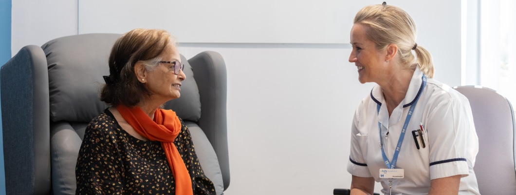 A Havens Hospices Care Staff member smiling and talking with a patient