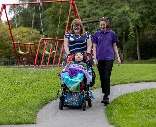 Elijah, his mum and Emma HCA walking round Little Havens