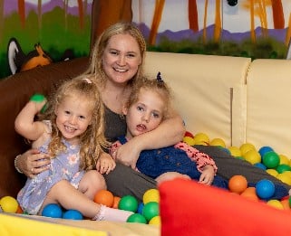 Lucy and her family in the ball pit at Little Havens