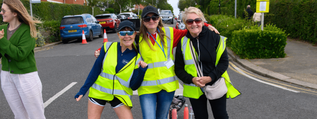 three marshalls wearing hi vis yellow vests