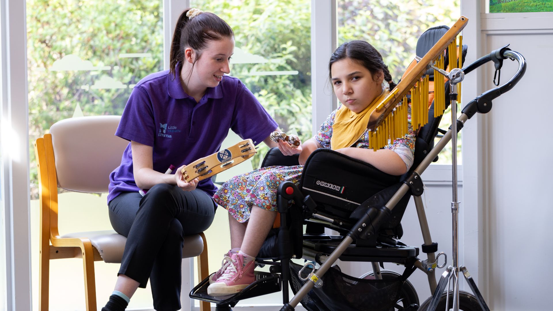 Little Havens child Alyssa with Care Team member Emma, making music