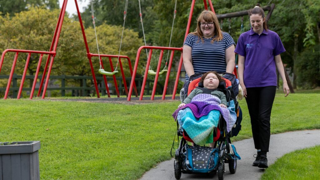 Elijah, Mum Natasha And Carer Emma walking in the Little Havens garden