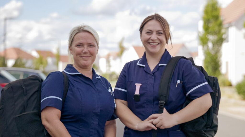 Two Fair Havens Community Nurses smiling at the camera
