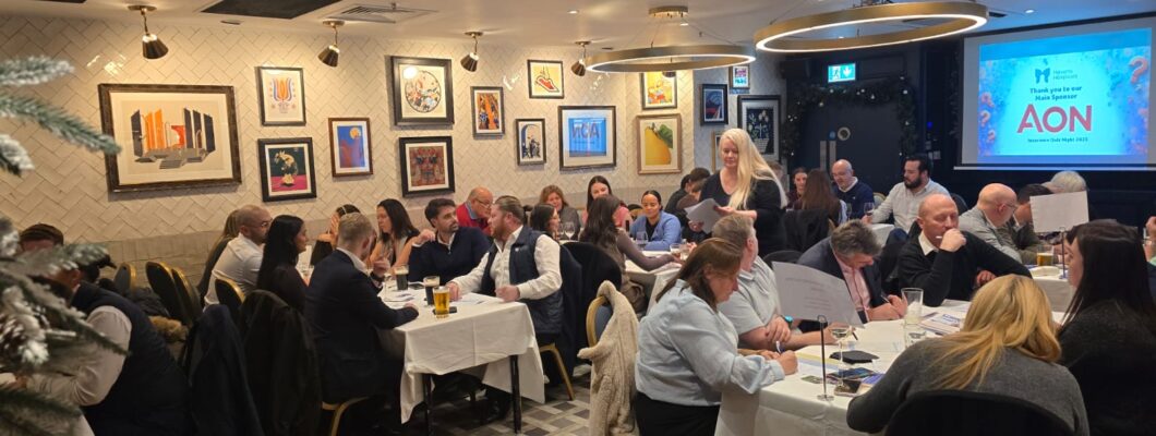 Quiz goers sitting at tables in teams
