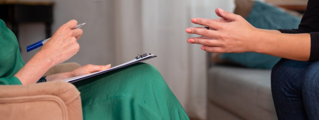 Close up of a client and counsellors hands, whilst they're in conversation