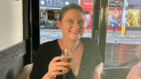 Alice having a glass of champagne to celebrate her end of treatment