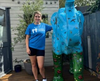Kat Smith wearing a Havens Hospices t-shirt With The Elephant Sculpture From Herd In The City Which She Purchased After The Trail To Raise Funds For Havens Hospices