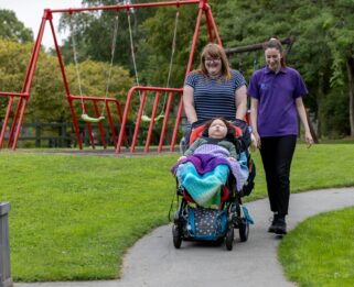 Elijah and mum Natasha and carer Emma in Little Havens garden