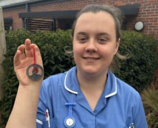 Fair Havens Nurse holding a Robin decoration