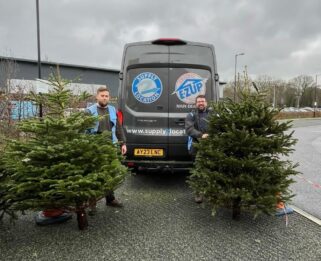 Christmas tree collection volunteers with Christmas trees