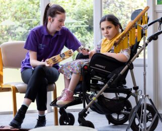 Alyssa and Care Team member Emma making music