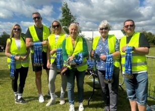 Volunteers handing out medals