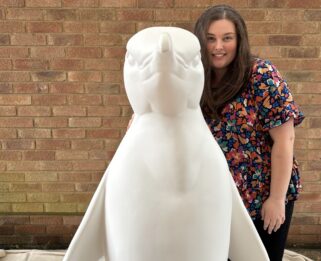 Local Artist Charlie Stafford with ppenguin sculpture.