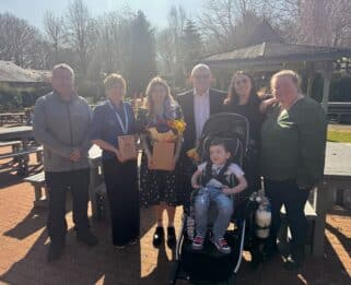 Donna and Lucy from the play team holding there medals with foster carers and representatives from Fostering Together.