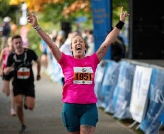 Lady crossing the line at Chelmsford Marathon