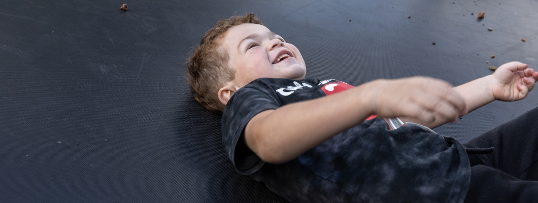 Little Havens child Lennie laughing on a trampoline