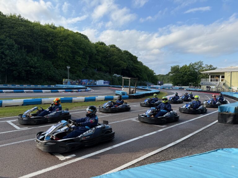 Go-Karts lined up on a track at the start of the charity race