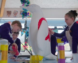 Grove Wood Primary School painting their penguin.