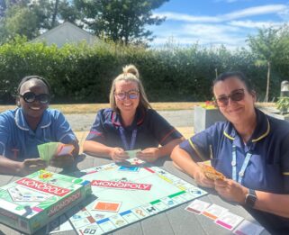 Nurse at Fair Havens with a Monopoly Board
